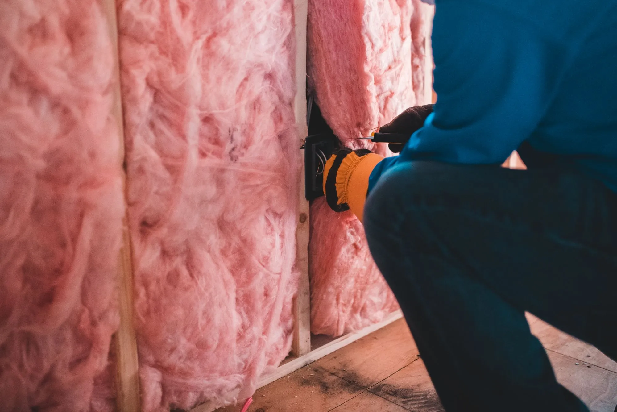Insulation and framing exposed in a loft during a leak investigation